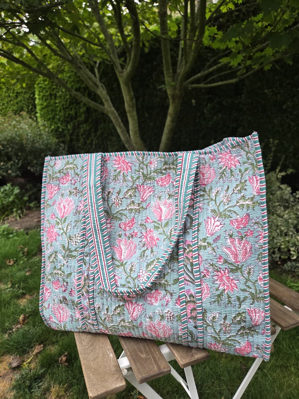 Block print quilted tote bag on garden chair