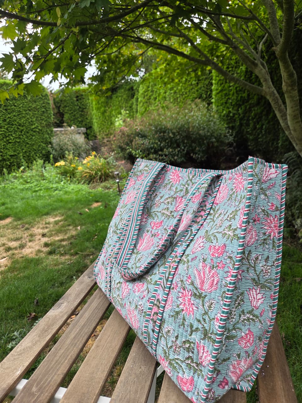 Block print quilted tote bag on garden bench
